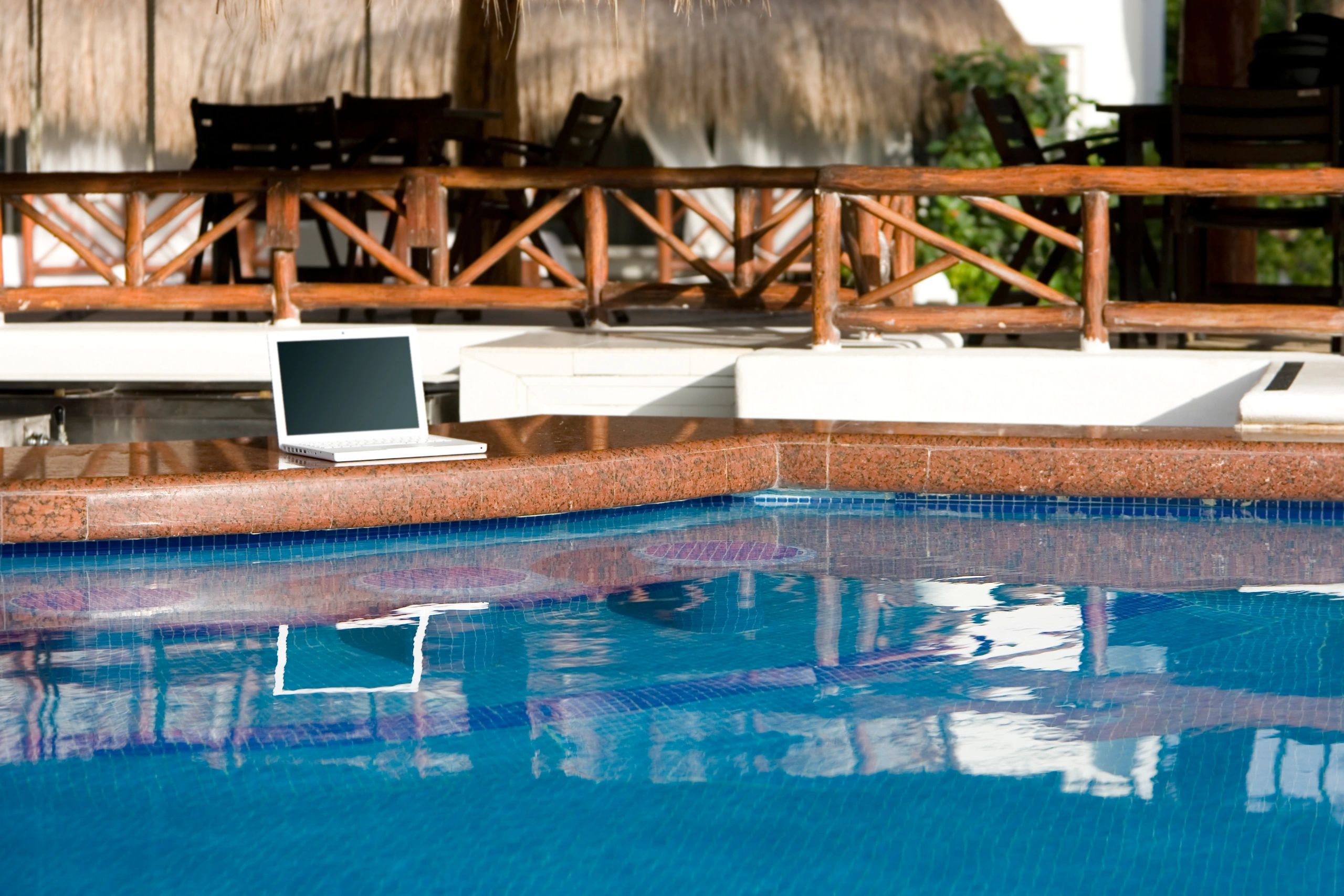 Clear blue swimming pool water in bright daylight